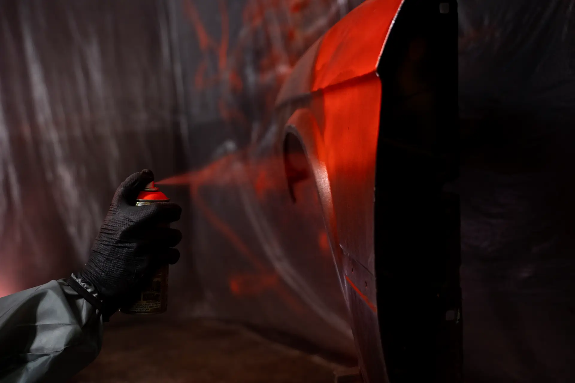side-view-hand-spraying-powder-paint-door