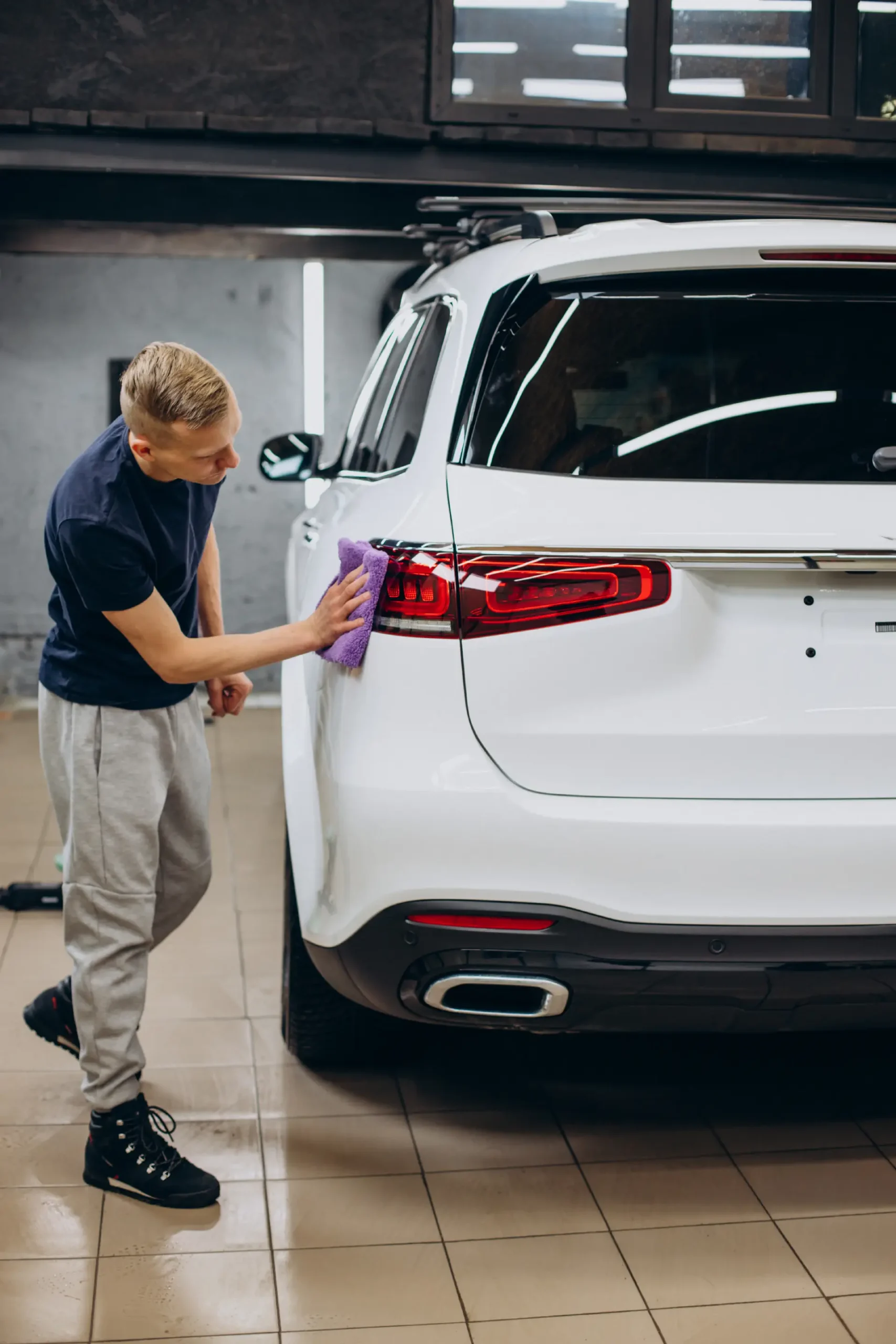 worker-car-detailing-cleaning-car-with-microfiber
